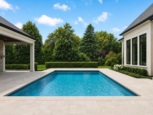 A bare pool deck with empty paving along the water