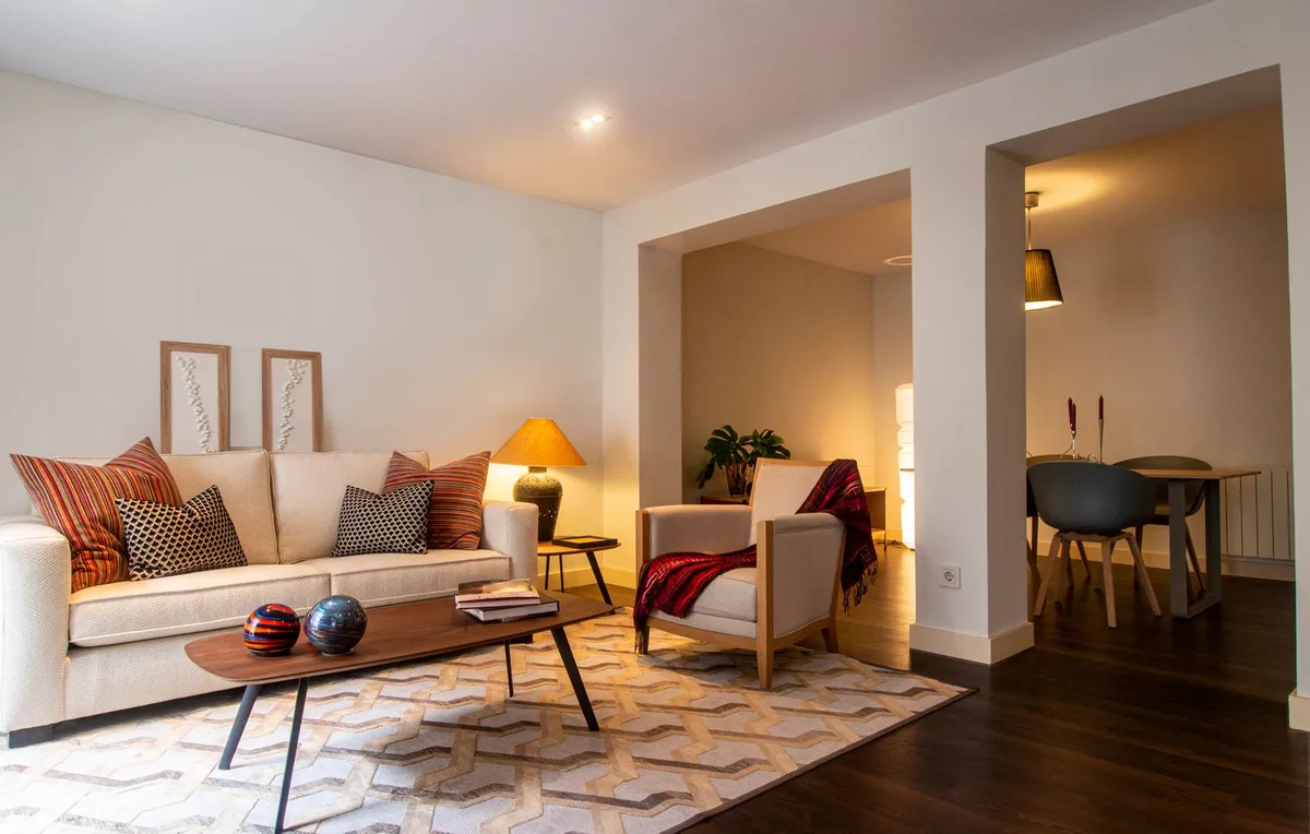 Cozy contemporary living room with warm ambient lighting in neutral tones